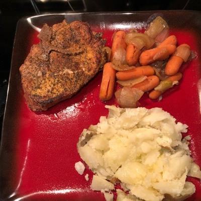 snelkookpan met boterkarbonades, gebakken aardappelen en wortels